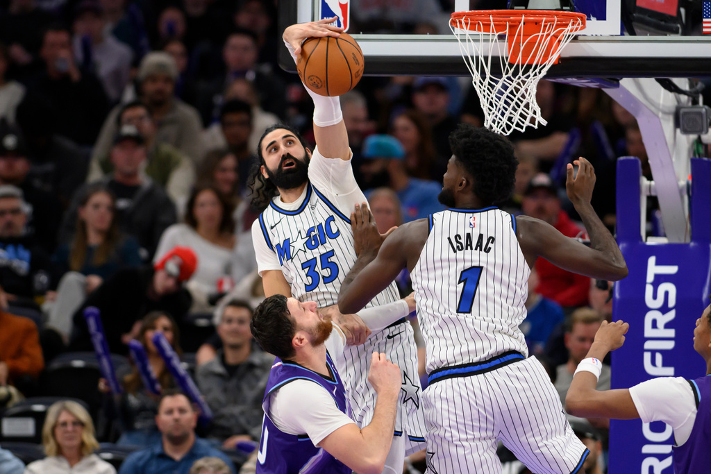 Orlando Magic center Goga Bitadze (35) blocks the shot of Utah Jazz center Jusuf Nurkic, bottom left, during the first half of an NBA basketball game, Saturday, Dec. 20, 2025, in Salt Lake City. (AP Photo/Tyler Tate)