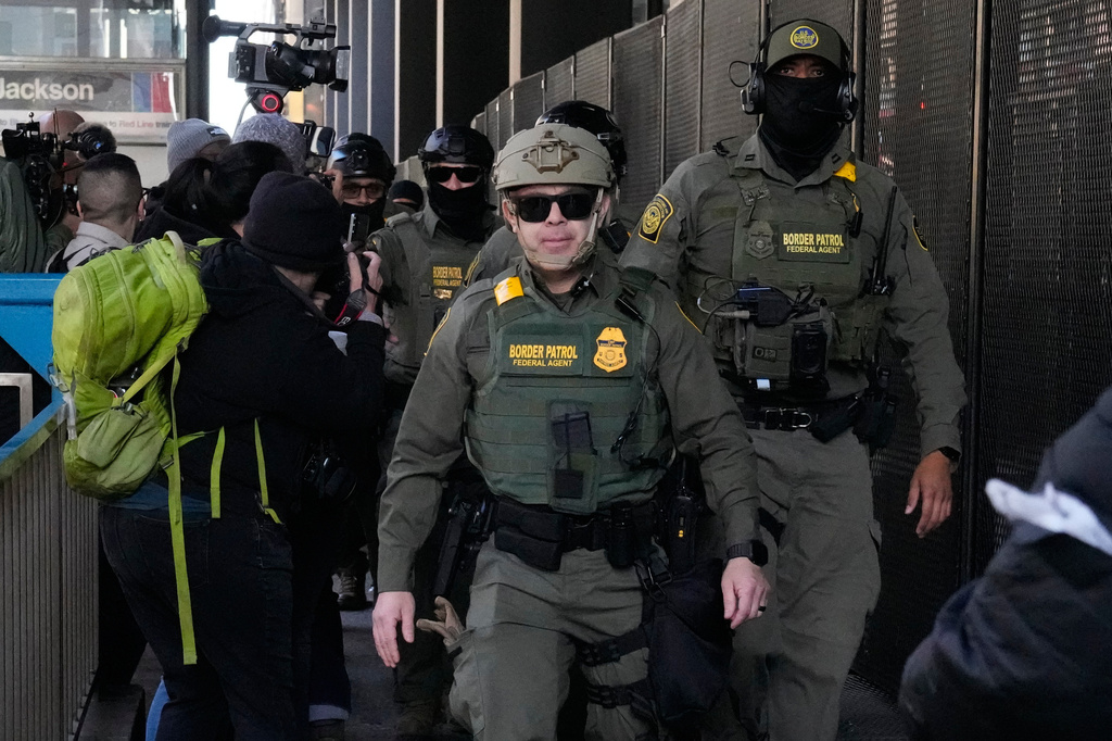 FILE - U.S. Customs and Border Patrol agents arrive to escort U.S. Customs and Border Patrol Gregory Bovino from federal court in Chicago, Oct. 28, 2025. (AP Photo/Nam Y. Huh, File)