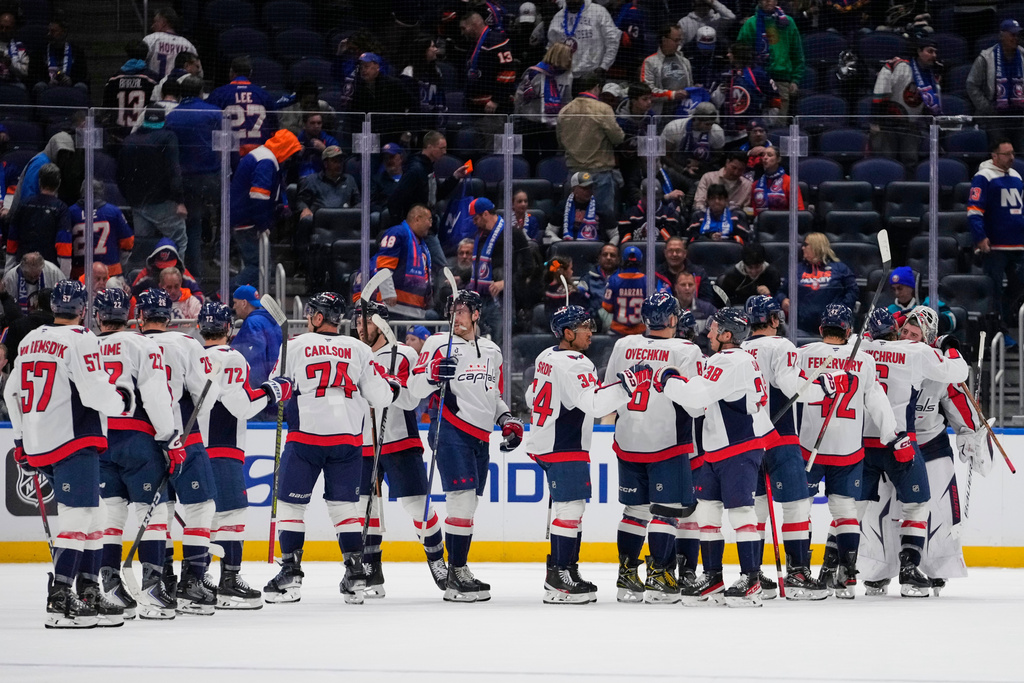 The Washington Capitals celebrate after an NHL hockey game against the New York Islanders Saturday, Oct. 11, 2025, in Elmont, N.Y. (AP Photo/Frank Franklin II)