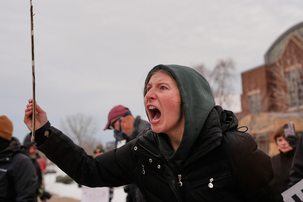 A protester shouts at federal immigration officers Sunday, Jan. 11, 2026, in Minneapolis. (AP Photo/Jen Golbeck)