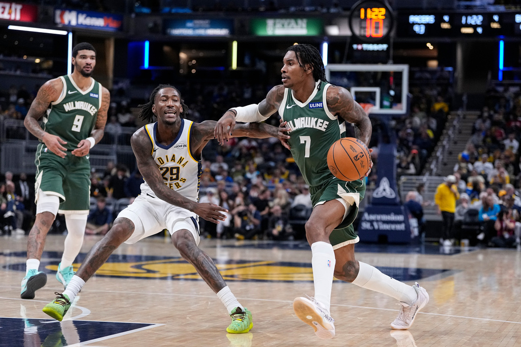 Milwaukee Bucks guard Kevin Porter Jr. (7) drives against Indiana Pacers guard Quenton Jackson (29) during the second half of a preseason NBA basketball game in Indianapolis, Friday, Oct. 16, 2026. (AP Photo/Michael Conroy)