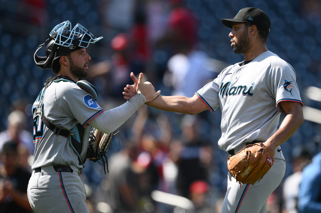 Miami Marlins relief pitcher Michael Petersen, right, celebrates with catcher Joe Mack, left, after a baseball game against the Washington Nationals, Sunday, Aug. 30, 2026, in Washington. (AP Photo/Nick Wass)