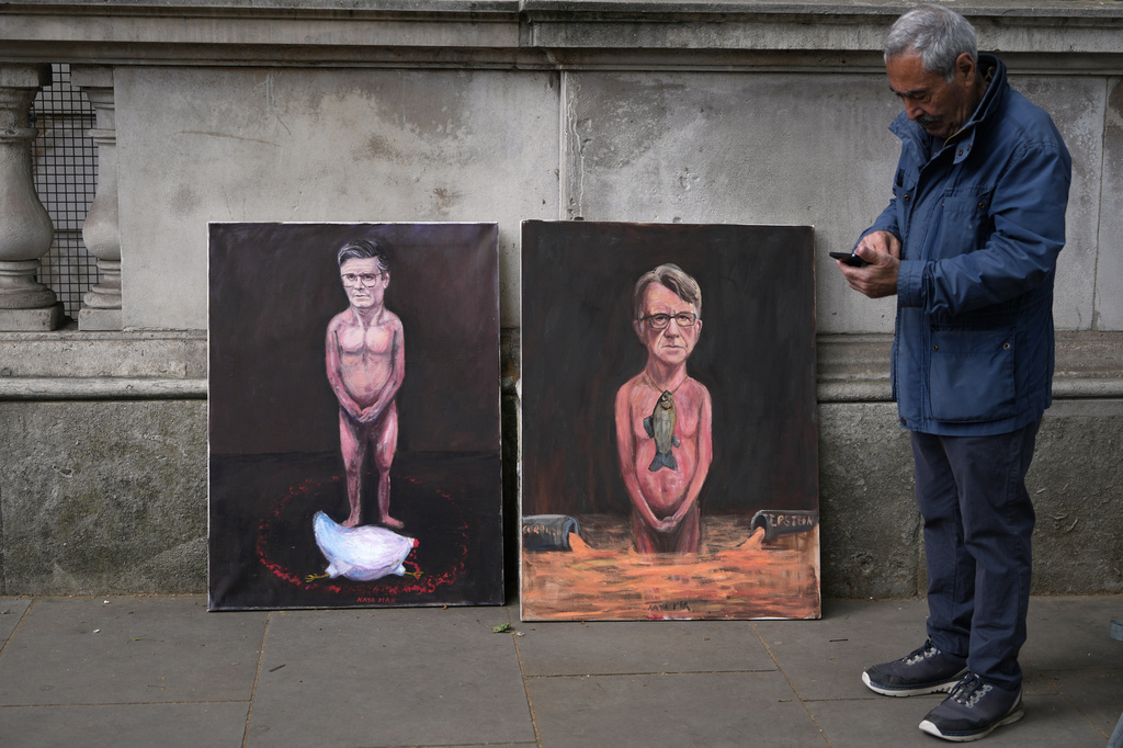 Artist Kaya Mar has his last paintings referring to Keir Starmer and Peter Mandelson on display in London, Monday, April 20, 2026 as Britain's Prime Minister Keir Starmer is facing a showdown in Parliament over the appointment of Peter Mandelson as ambassador to Washington.(AP Photo/Alastair Grant)