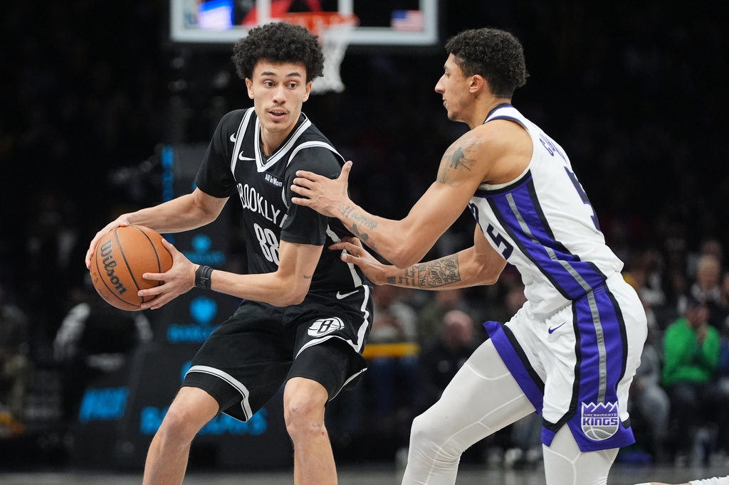Sacramento Kings' Nique Clifford (5) defends Brooklyn Nets' Nolan Traore (88) during the second half of an NBA basketball game Sunday, March 29, 2026, in New York. (AP Photo/Frank Franklin II)