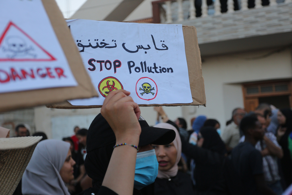 People take part in a demonstration against pollution caused by chemical factories, in Gabes, Tunisia, Wednesday, Oct. 16, 2025. Banner in Arabic reads "Gabes is suffocating." (AP Photo/Bassem Aouini)