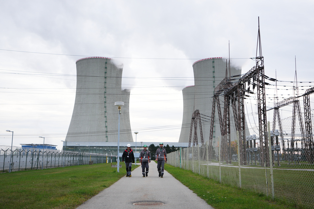 Workers walk past cooling towers of the Dukovany nuclear power plant in Dukovany, Czech Republic, Oct. 21, 2025. (AP Photo/Petr David Josek)