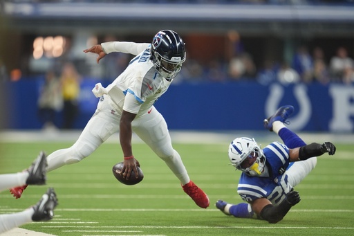 Tennessee Titans quarterback Cam Ward (1) runs from Indianapolis Colts safety Nick Cross (20) during the first half an NFL football game, Sunday, Oct. 26, 2025, in Indianapolis. (AP Photo/Michael Conroy) Tennessee Titans quarterback Cam Ward (1) runs from Indianapolis Colts safety Nick Cross (20) during the first half an NFL football game, Sunday, Oct. 26, 2025, in Indianapolis. (AP Photo/Michael Conroy)