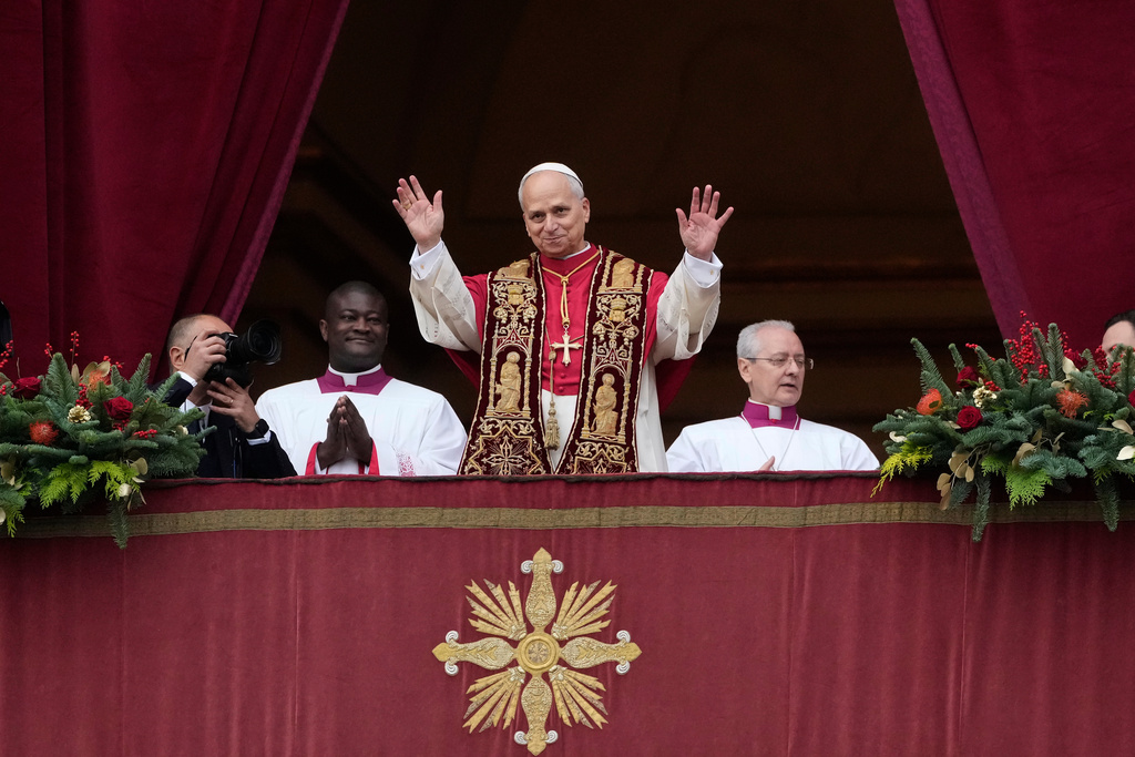 Pope Leo XIV waves after delivering the Urbi et Orbi (Latin for 'to the city and to the world' ) Christmas' day blessing from the main balcony of St. Peter's Basilica at the Vatican, Thursday, Dec. 25, 2025. (AP Photo/Gregorio Borgia)