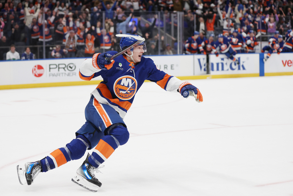 New York Islanders' Matthew Schaefer celebrates after his goal in the overtime period of an NHL hockey game against the Toronto Maple Leafs, Saturday, Jan. 3, 2026, in Elmont, N.Y. (AP Photo/Heather Khalifa)
