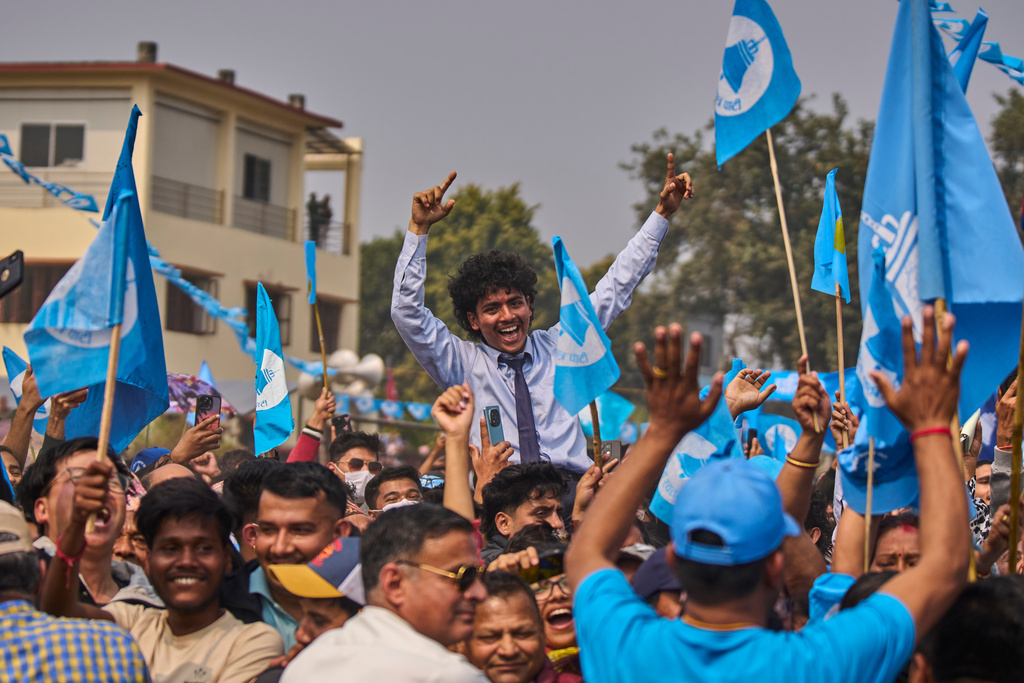 Supporters of the Rastriya Swatantra Party shout slogans as they wait for the arrival of rapper-turned-politician Balendra Shah during an election campaign rally in Chitwan, approximately 180 kilometers (112 miles) west of Kathmandu, Nepal, Friday, Feb. 27, 2026. (AP Photo/Niranjan Shrestha)