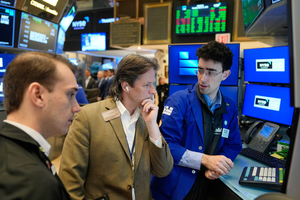 Patrick McKeon, center, works on the floor at the New York Stock Exchange in New York, Tuesday, March 31, 2026. (AP Photo/Seth Wenig)