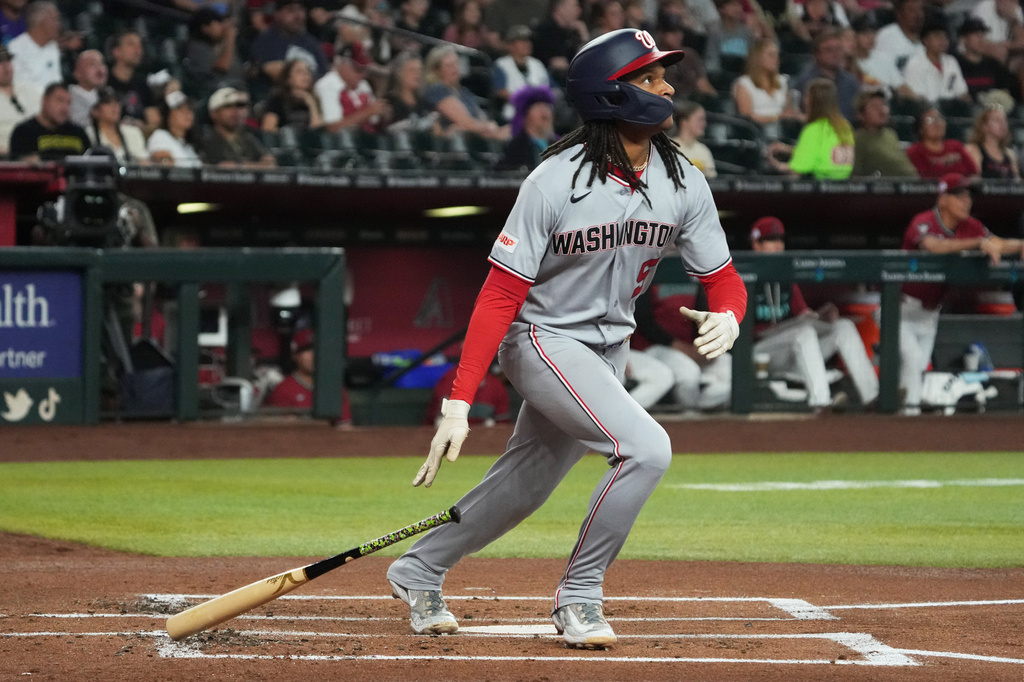 Washington Nationals CJ Abrams hits a solo home run against the Arizona Diamondbacks in the second inning of a baseball game, Sunday, June 7, 2026, in Phoenix. (AP Photo/Rick Scuteri)