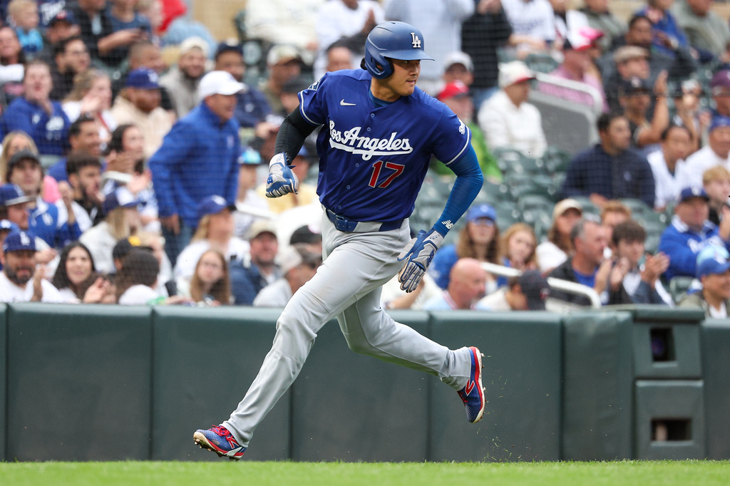 Los Angeles Dodgers designated hitter Shohei Ohtani rounds third base to score on a single hit by Tommy Edman during the first inning of a baseball game against the Minnesota Twins, Tuesday, June 23, 2026, in Minneapolis. (AP Photo/Matt Krohn)