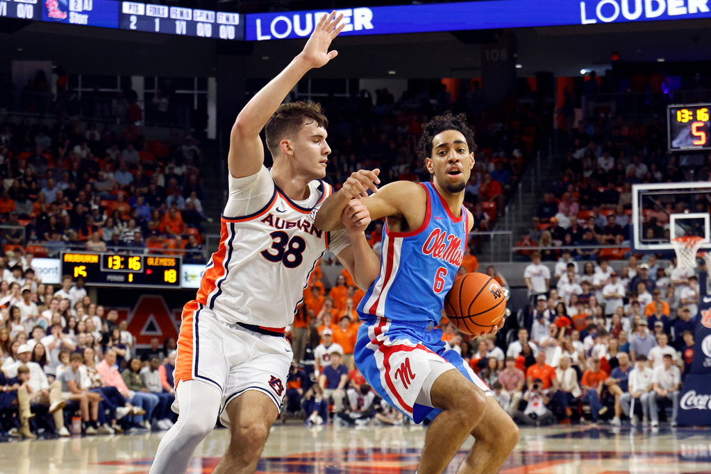 Mississippi guard Ilias Kamardine (6) tries to get around Auburn forward Filip Jovic (38) during the first half of an NCAA college basketball game Saturday, Feb. 28, 2026, in Auburn, Ala. (AP Photo/Butch Dill)