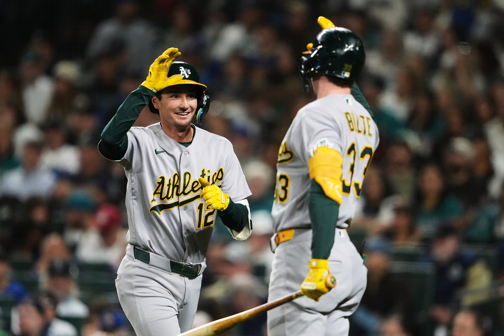 Athletics' Alika Williams (12) greets teammate Henry Bolte (33) after hitting a solo home run against the Seattle Mariners during the third inning of a baseball game, Friday, Sept. 4, 2026, in Seattle. (AP Photo/Lindsey Wasson)