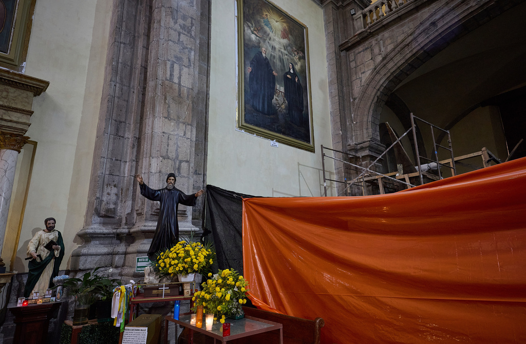 Tarps and scaffolding are used for repairs inside San Juan de Dios church in Mexico City, Friday, Sept. 19, 2025. The church withstood the 8.0 earthquake of 1985, however, its structure was severely damaged in 2017 and it was forced to shut down and reopened in late 2024 after most of its restoration was completed. (AP Photo/Ginnette Riquelme)