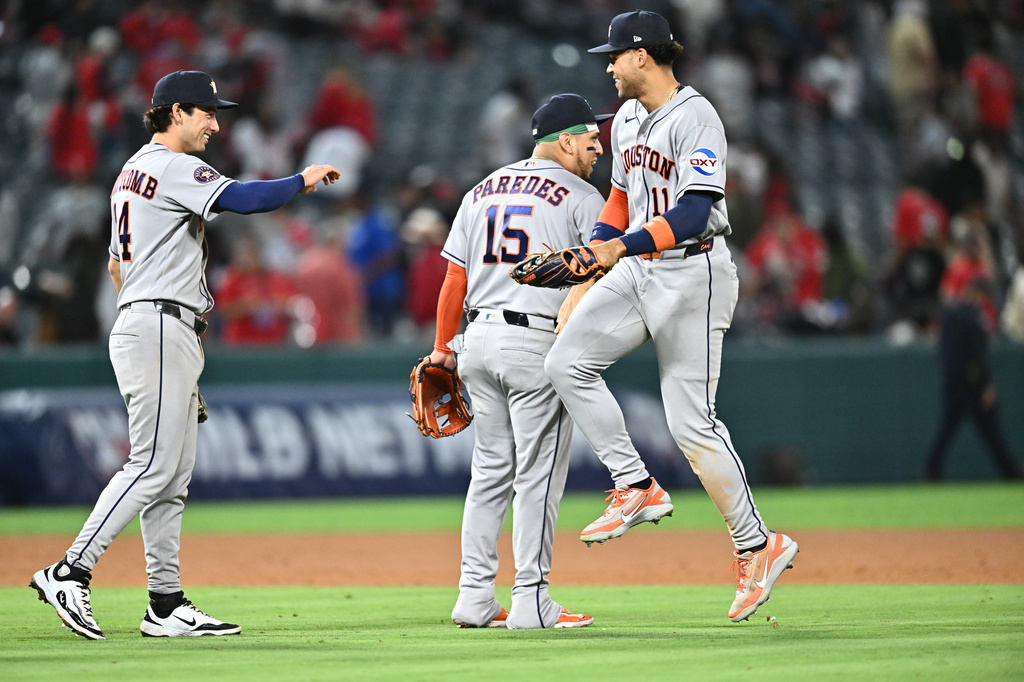 Houston Astros right fielder Cam Smith, right, is greeted by third baseman Isaac Paredes (15) after defeating the Los Angeles Angels in a baseball game Monday, June 8, 2026, in Anaheim, Calif. (AP Photo/William Liang)