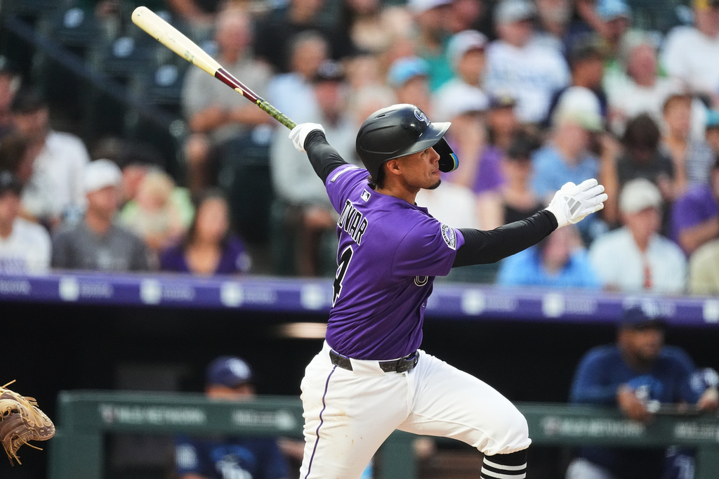 Colorado Rockies' Ezequiel Tovar follows the flight of his solo home run off Tampa Bay Rays starting pitcher Ian Seymour in the third inning of a baseball game Monday, Aug. 3, 2026, in Denver. (AP Photo/David Zalubowski)