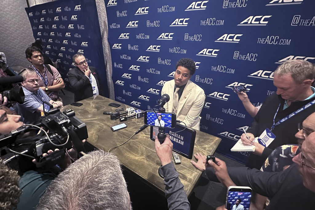 Miami quarterback Darian Mensah listens during ACC Kickoff preseason football media days, Wednesday, July 15, 2026 in Charlotte, N.C. (AP Photo/Aaron Beard)