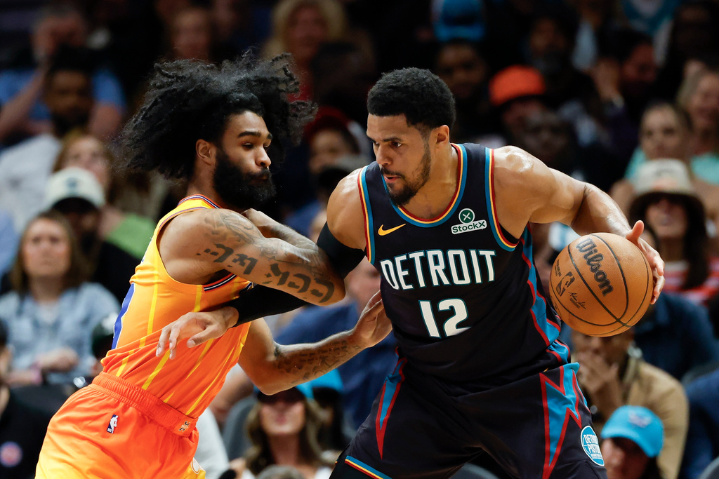 Detroit Pistons forward Tobias Harris (12) drives into Charlotte Hornets guard Coby White, left, during the first half of an NBA basketball game in Charlotte, N.C., Friday, April 10, 2026. (AP Photo/Nell Redmond)