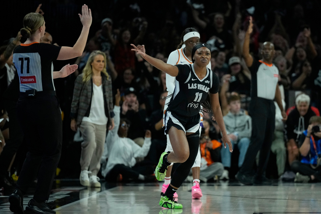 Las Vegas Aces guard Dana Evans (11) celebrates a three pointer against the Phoenix Mercury during the first half in Game 1 of a WNBA basketball final playoff series Friday, Oct. 3, 2025, in Las Vegas. (AP Photo/John Locher)
