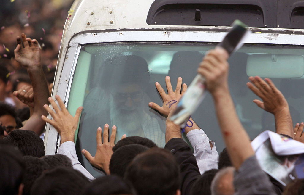 FILE - Iranians wave to the supreme leader Ayatollah Ali Khamenei as he arrives in Semnan, Iran, Nov. 8, 2006. (Morteza Farajabadi, ISNA via AP Photo/ File)