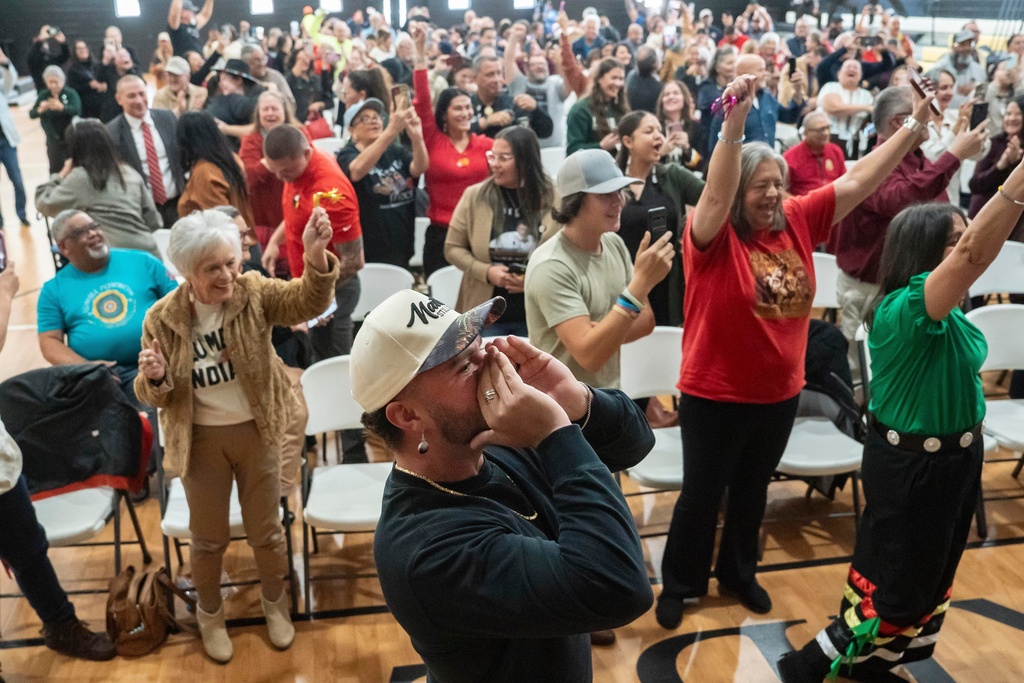 People celebrate after passage of the National Defense Authorization Act by the U.S. Senate during a watch party hosted by the Lumbee Tribe of North Carolina, Wednesday, Dec. 17, 2025, in Pembroke, N.C. (AP Photo/Allison Joyce)