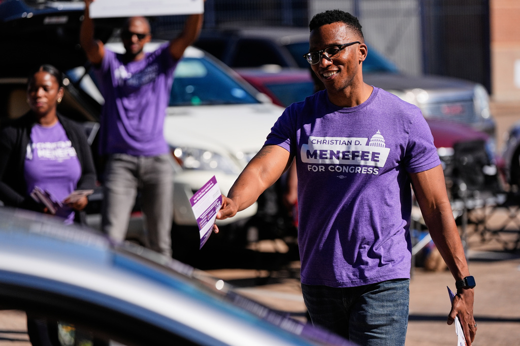 Democratic 18th Congressional District candidate Christian Menefee greets voters near a polling place on Tuesday, Nov. 4, 2025, in Houston. (AP Photo/Ashley Landis)
