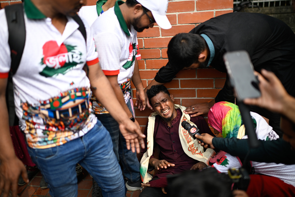 An injured protester speaks to the media outside Bangladesh's national parliament complex in Dhaka, Bangladesh, Friday, Oct. 17, 2025. (AP Photo/Mahmud Hossain Opu)