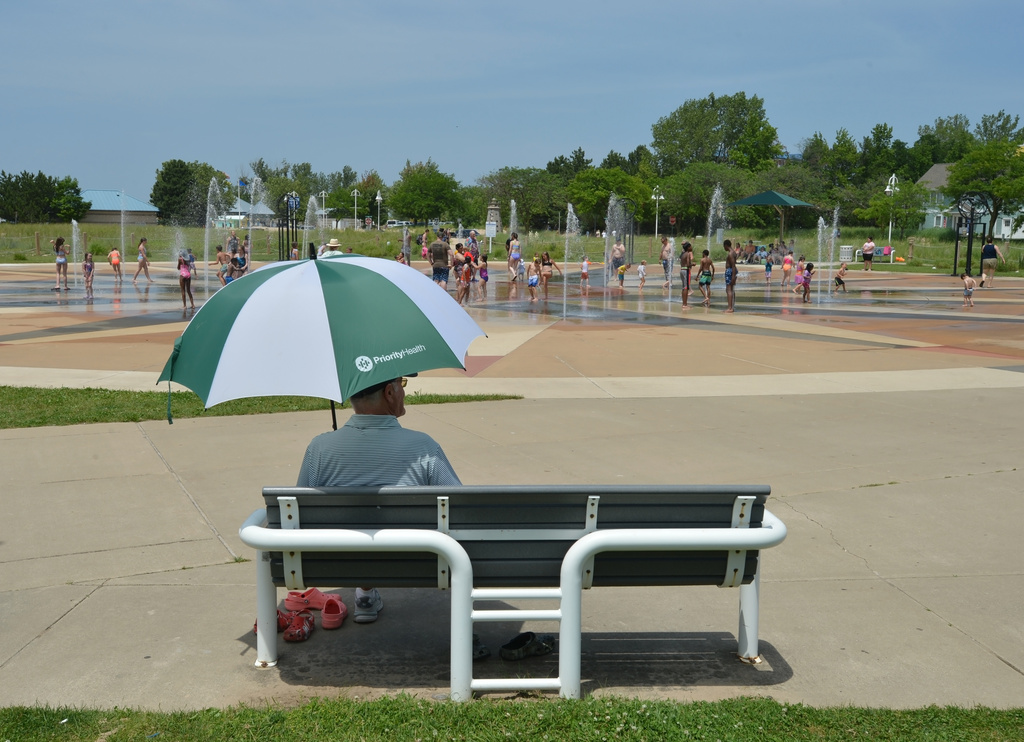 Children and adults cool off in the Whirlpool Compass Fountain Tuesday, June 30, 2026, in St. Joseph, Mich. (Don Campbell/The Herald-Palladium via AP)