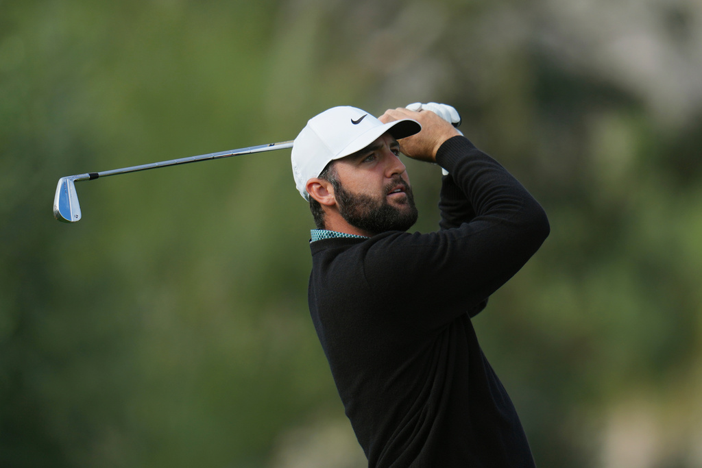 Scottie Scheffler watches his shot from the third tee during the first round of the American Express golf event at La Quinta County Club Thursday, Jan. 22, 2026, in La Quinta, Calif. (AP Photo/Ross D. Franklin)