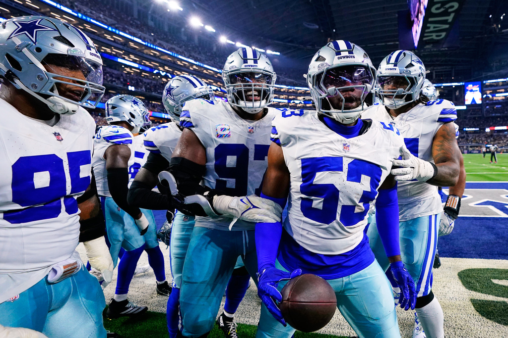 Dallas Cowboys defensive end James Houston (53), Osa Odighizuwa, and Kenny Clark (95) celebrate with others after Houston recovered a Green Bay Packers fumble in the first half of an NFL football game Sunday, Sept. 28, 2025, in Arlington, Texas. (AP Photo/Jeffrey McWhorter)