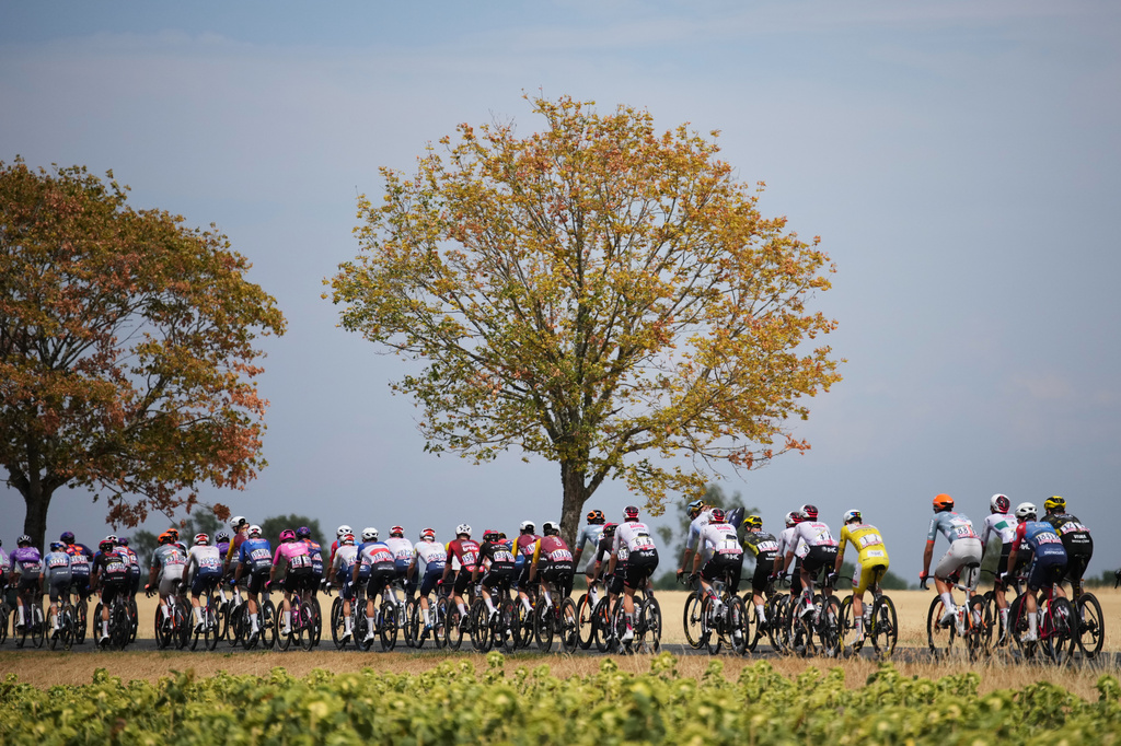 Slovenia's Tadej Pogacar, wearing the overall leader's yellow jersey, rides with the pack during the eleventh stage of the Tour de France cycling race with start in Vichy and finish in Nevers, France, Wednesday, July 15, 2026. (AP Photo/Mosa'ab Elshamy)