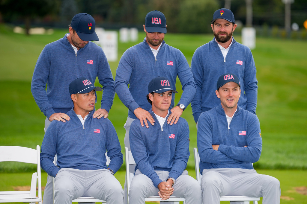 Seated from left; Collin Morikawa, Jackson Koivun and Russell Henley wait with, from left, Sam Burns, Wyndham Clark and Cameron Young for USA teams portrait prior to the start of the Presidents Cup golf tournament at Medinah Country Club, Wednesday, Sept. 23, 2026, in Medinah, Ill. (AP Photo/Matt Slocum)