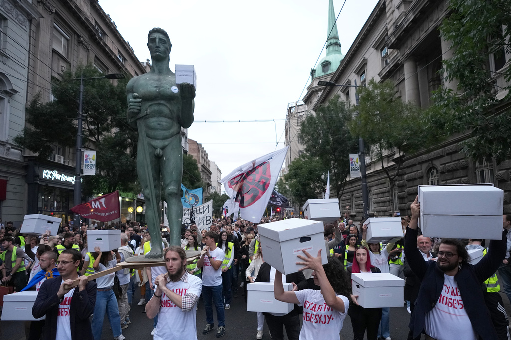 Political candidates, students and citizens carry signatures for the "Student list - Students win" to the Republic Election Commission towards participation in the upcoming parliamentary elections in Belgrade, Serbia, Monday, Sept. 14, 2026. (AP Photo/Darko Vojinovic)