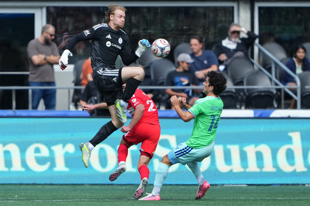 Chicago Fire FC goalkeeper Chris Brady clears the ball against Seattle Sounders midfielder Paul Rothrock, right, during the first half of an MLS soccer match, Saturday, Aug. 29, 2026, in Seattle. (AP Photo/Lindsey Wasson)