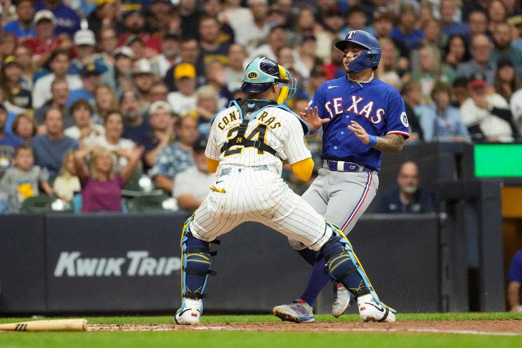 Milwaukee Brewers' William Contreras (24) tags out Texas Rangers' Cody Freeman at home during the third inning of a baseball game Saturday, Aug. 29, 2026, in Milwaukee. (AP Photo/Aaron Gash)