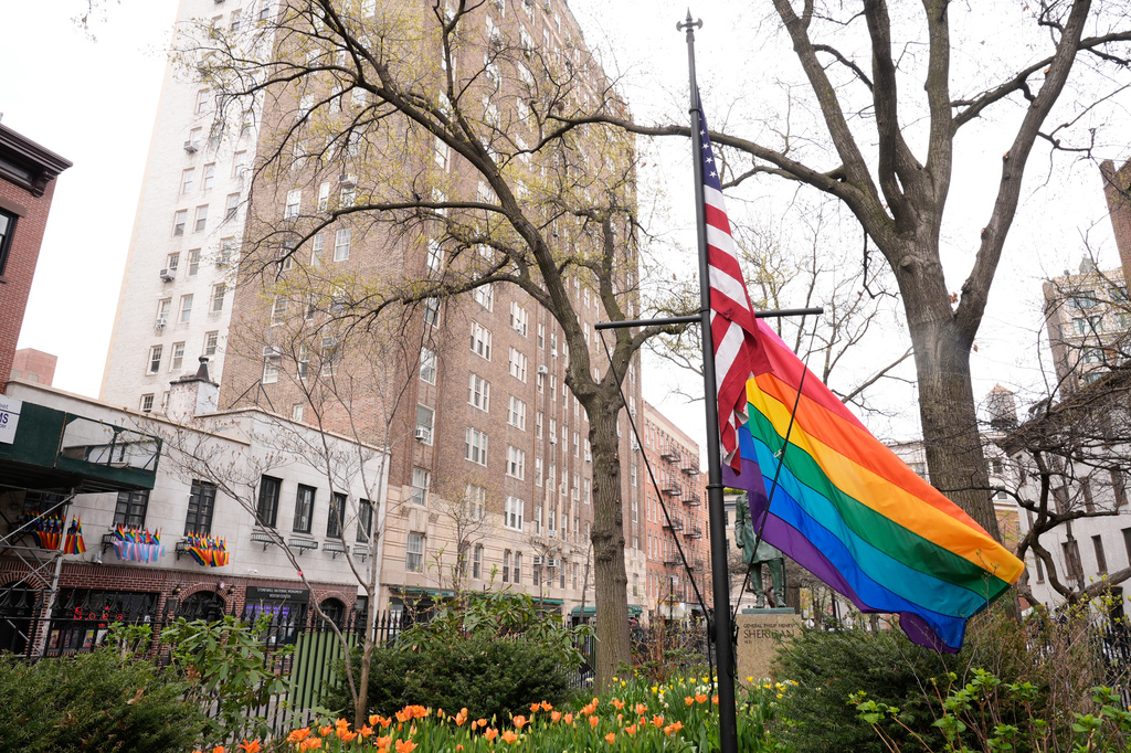 A rainbow Pride flag flies with an American flag at the Stonewall National Monument in New York, Monday, April 13, 2026. (AP Photo/Seth Wenig)