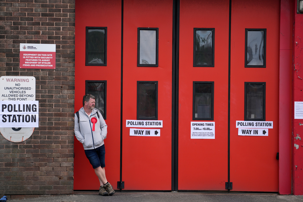 A voter waits outside the Hindley Community Fire station which is converted into a polling station for the by-election in Makerfield, England, Thursday, June 18, 2026 where voters are choosing a new lawmaker with Andy Burnham of the Labour Party as the leading contender.(AP Photo/Jon Super)