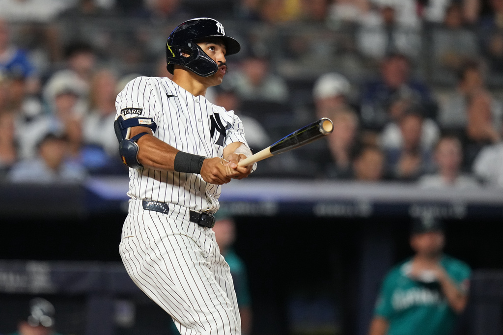 New York Yankees' Trent Grisham follows through on a home run during the fifth inning of a baseball game against the Seattle Mariners Wednesday, Aug. 12, 2026, in New York. (AP Photo/Frank Franklin II)