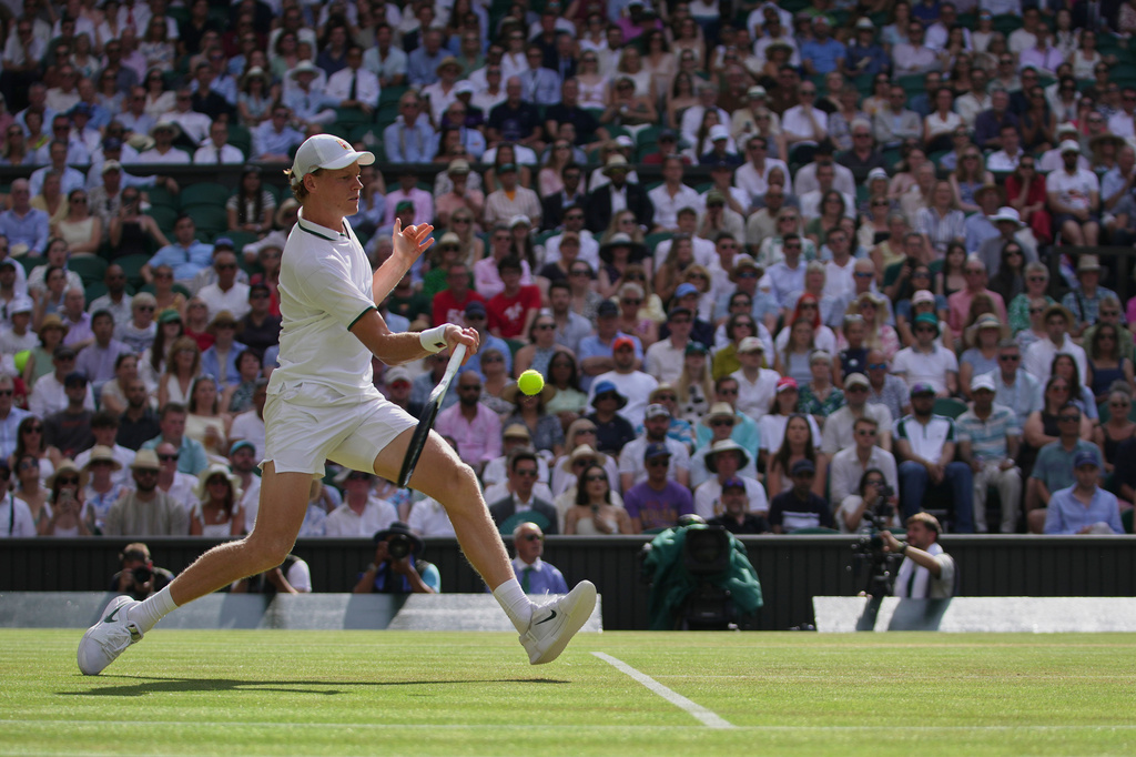 Jannik Sinner of Italy returns the ball to Novak Djokovic of Serbia in their men's singles semifinal match at the Wimbledon Tennis Championships in London, Friday, July 10, 2026. (AP Photo/Brian Inganga)