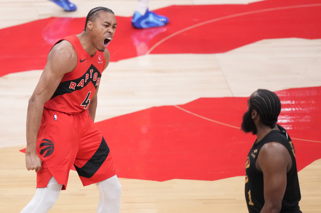 Toronto Raptors forward Scottie Barnes (4) reacts after making a basket as Cleveland Cavaliers guard James Harden (1) looks on during the first half of Game 4 in a first-round NBA basketball playoffs series in Toronto, Sunday, April 26, 2026. (Nathan Denette/The Canadian Press via AP)