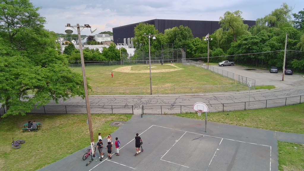 FILE - A data center built by the Markley Group is seen over a ballpark and residential neighborhood in Lowell, Mass., June 30, 2026. (AP Photo/Matt O'Brien, File)