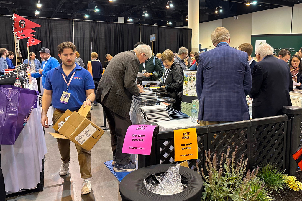 Author and former Omaha World-Herald reporter Steve Jordan signs copies of his book at the Berkshire Hathaway shareholders event on Friday, May 1, 2026 in Omaha, Neb. (AP Photo/Josh Funk)
