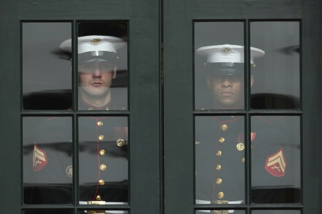 U.S. Marine Corps prepare to open the doors to the Diplomatic Reception Room for visiting Saudi Arabia's Crown Prince Mohammed bin Salman at the White House, Tuesday, Nov. 18, 2025, in Washington. (AP Photo/Mark Schiefelbein)