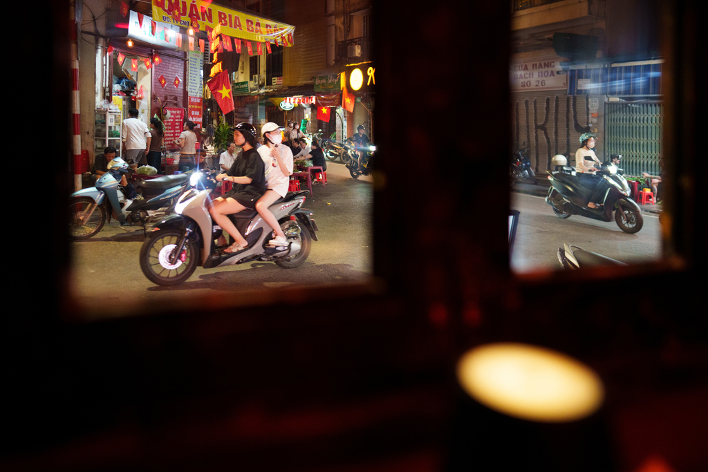 CORRECTS TO CALL THE AREA THE OLD QUARTER - Vietnamese girls ride two-wheelers in the Old Quarter area in Hanoi, Vietnam, on Sept. 4, 2025. (AP Photo/Vincent Thian)