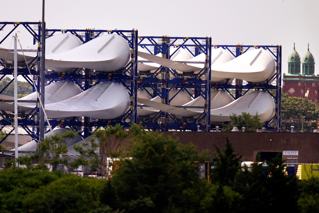 FILE - Giant wind turbine blades for the Vineyard Winds project are stacked on racks in the harbor, July 11, 2023, in New Bedford, Mass. (AP Photo/Charles Krupa, File)