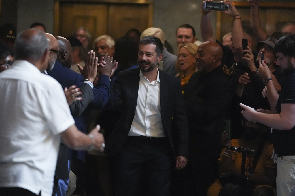 Former Transportation Secretary Pete Buttigieg makes his way through the crowd before speaking at a rally at the Statehouse in Indianapolis, Thursday, Sept. 18, 2025 for Indiana Democrats amid pressure from President Donald Trump on Republicans who control the state's legislature to redistrict congressional seats. (AP Photo/Michael Conroy)