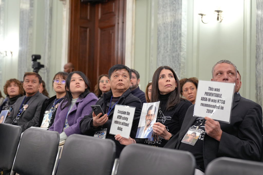 Family members of the people who were killed in the midair collision near Washington Reagan National Airport watch a video before a Senate Committee on Commerce, Science, and Transportation hearing at Capitol Hill, Thursday, Feb. 12, 2026, in Washington. (AP Photo/Mariam Zuhaib)