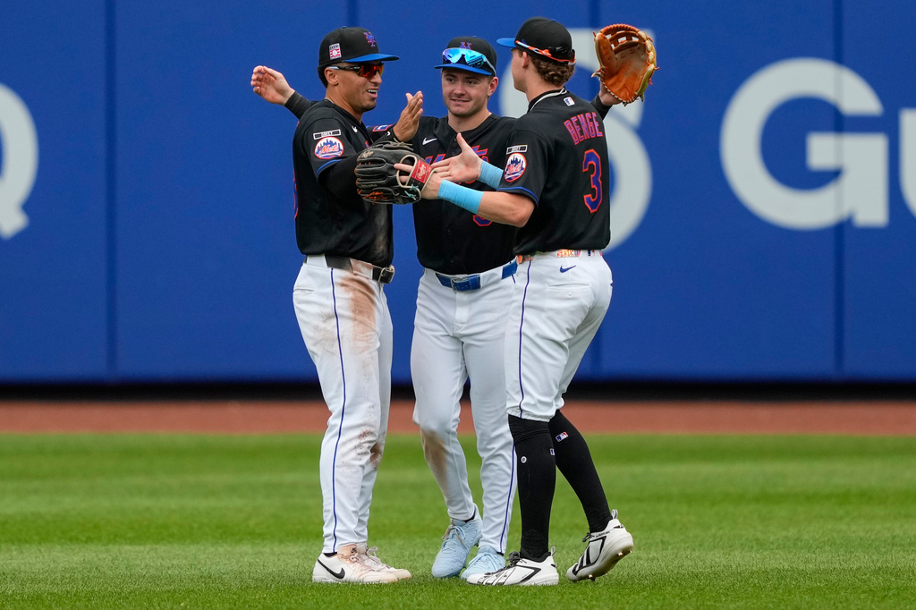 New York Mets right fielder Carson Benge, right, center fielder A.J. Ewing, center, and left fielder Tyrone Taylor, left, celebrate after winning a baseball game against the Los Angeles Dodgers, Sunday, July 26, 2026, in New York. (AP Photo/Yuki Iwamura)